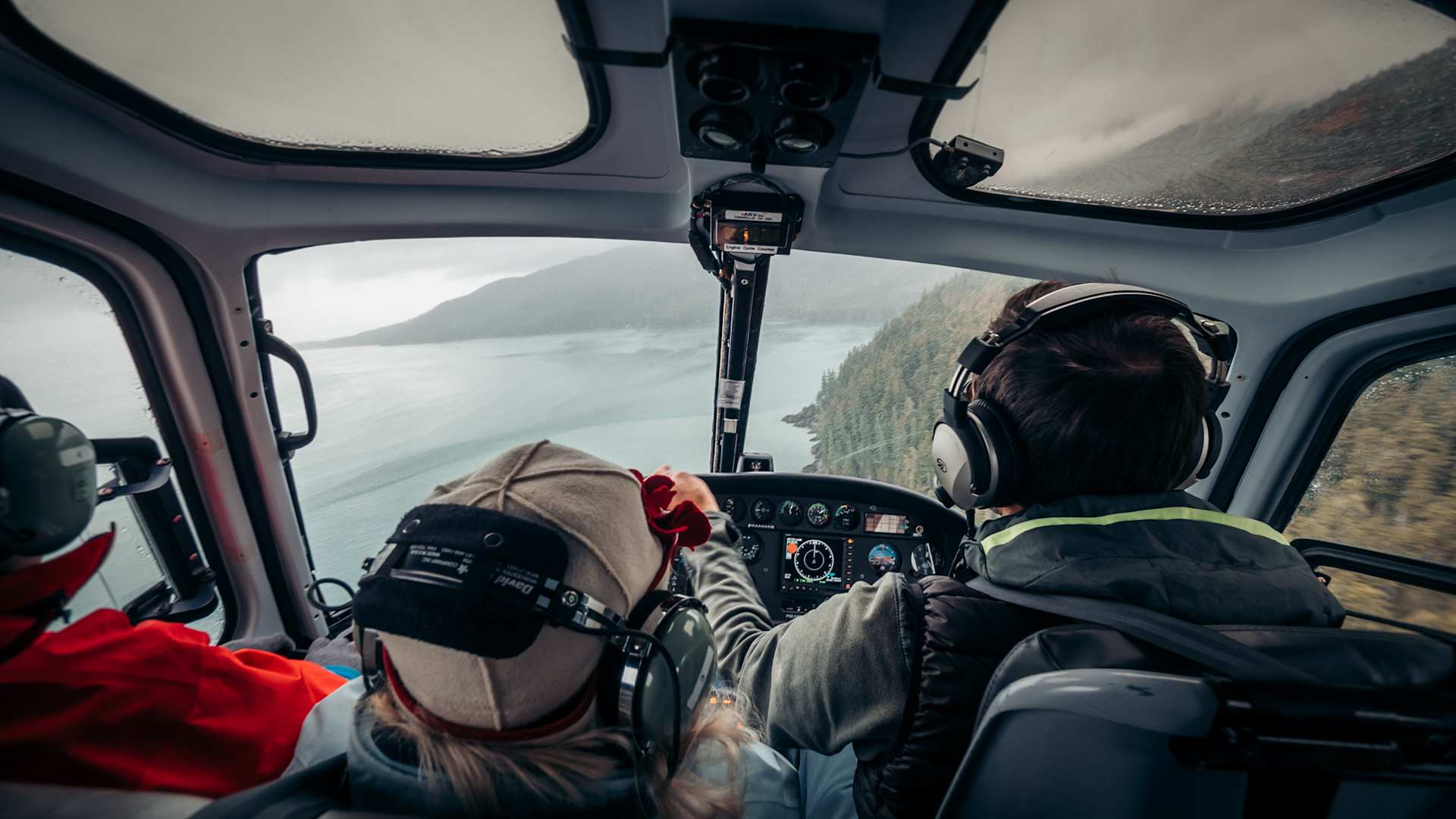 Windstar Cruise passengers flying in a helicopter over an Alaskan forest
