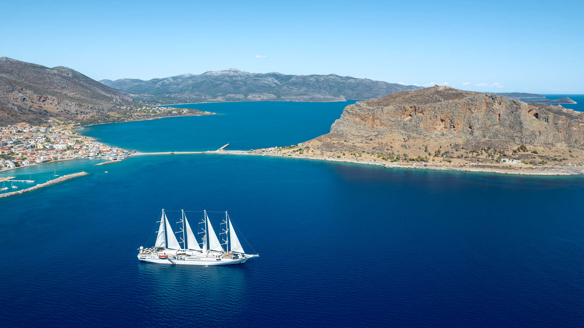 Sail in style on one of our Wind Class yachts, complete with billowing white sails.