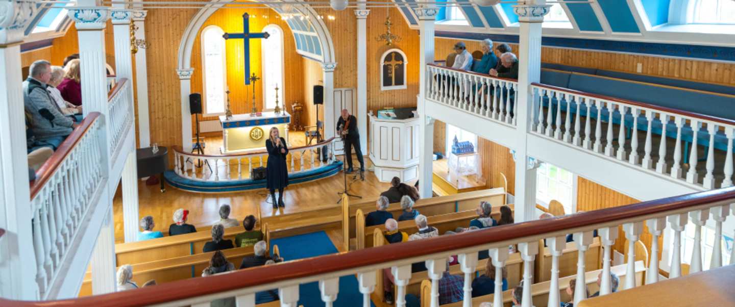 Local musicians fill the town's glacier-blue church with songs and stories of ghosts, elves and lost sailors. 
