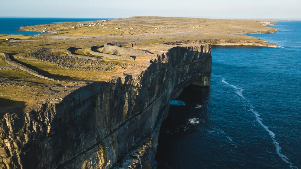 Step ashore at Inis Mór, largest of Ireland’s Aran Islands, where prehistoric stone forts crown Atlantic cliffs.